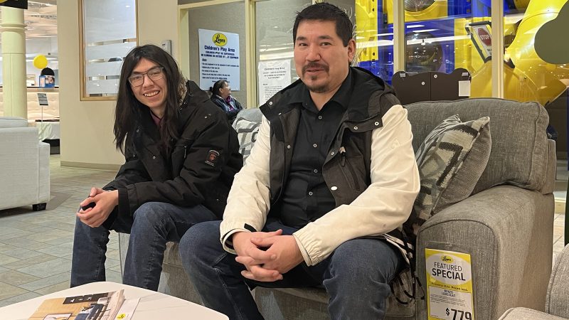 Darwyn and his son looking for furniture.